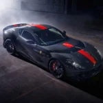 Ferrari 812 Competizione black supercar with red racing stripes parked in a dark garage surrounded by smoke — cinematic luxury car wallpaper.