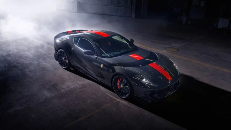 Ferrari 812 Competizione black supercar with red racing stripes parked in a dark garage surrounded by smoke — cinematic luxury car wallpaper.
