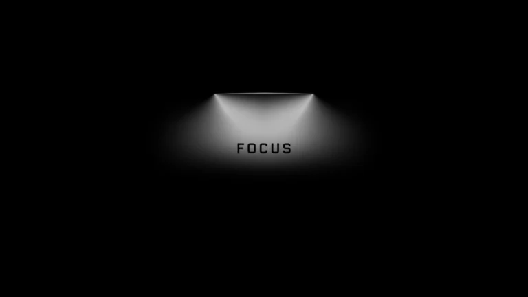 minimal black wallpaper with spotlight and focus text centered in soft light for productivity motivation wallpaper