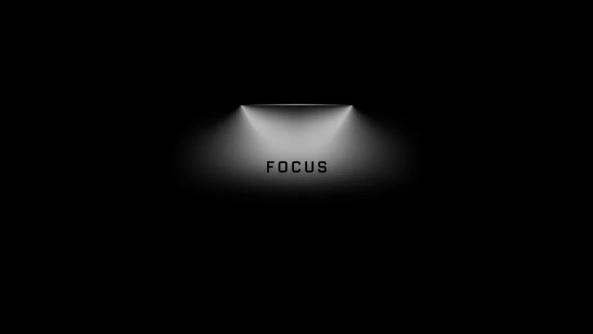 minimal black wallpaper with spotlight and focus text centered in soft light for productivity motivation wallpaper