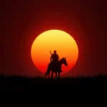 cowboy on horse silhouette against large red sunset horizon wild west landscape wallpaper