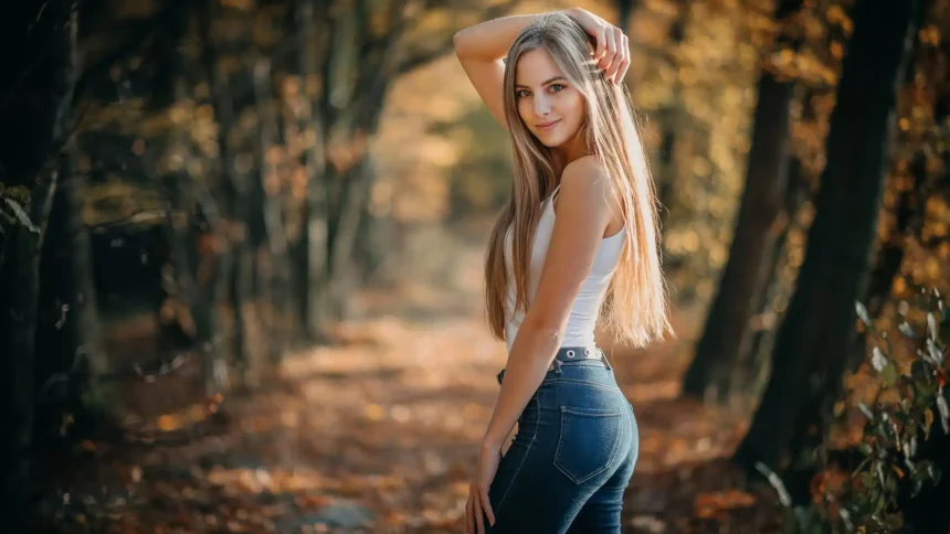autumn forest girl natural portrait warm golden leaves sunlight outdoor aesthetic peaceful fall scene uhd wallpaper