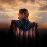 Homelander from The Boys Season 5 with glowing red eyes and American flag cape at sunset wallpaper