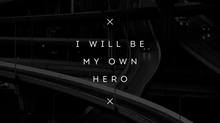 Dark motivational wallpaper with the quote I Will Be My Own Hero over a cinematic black highway background