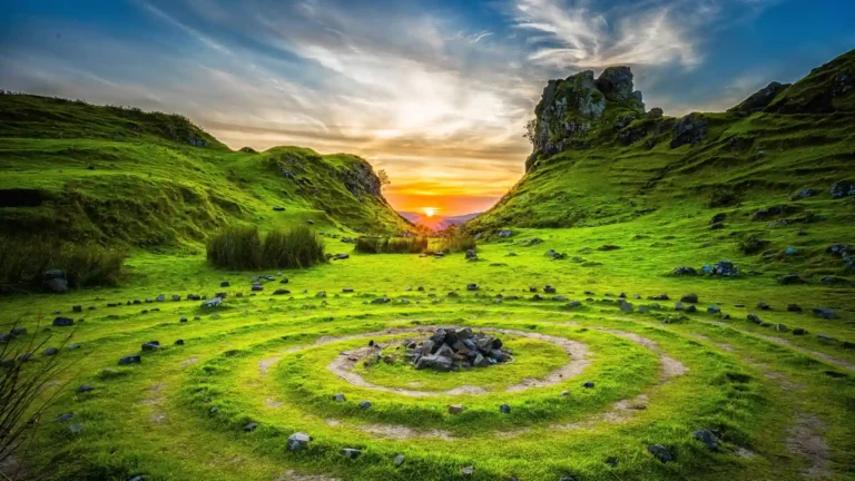 Green valley landscape at Isle of Skye with circular stone pattern and glowing sunset sky wallpaper