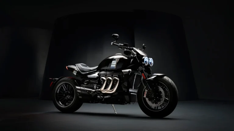 Black Triumph Rocket motorcycle in a dark studio with dramatic lighting wallpaper