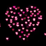 Pink glowing heart bokeh lights on dark romantic background wallpaper