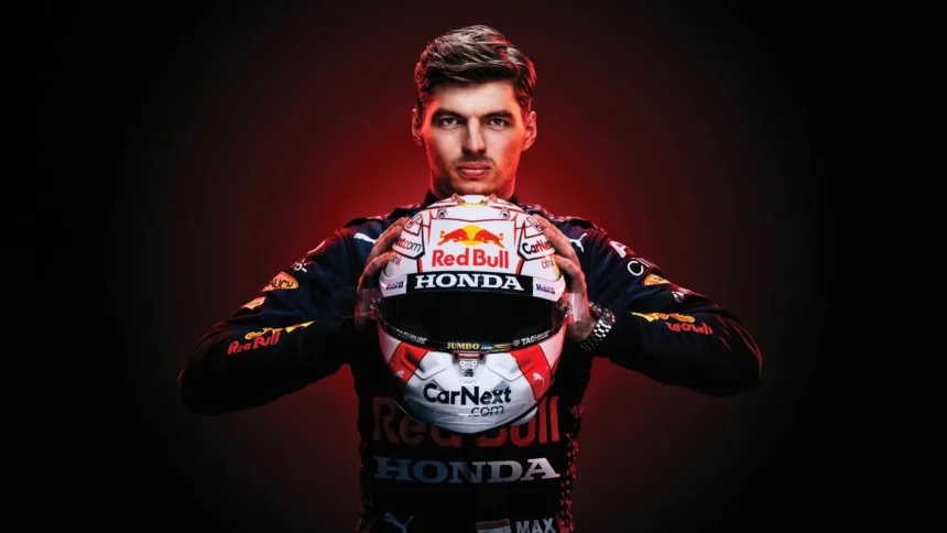 Max Verstappen holding his Red Bull Racing Formula One helmet in a dramatic championship portrait wallpaper