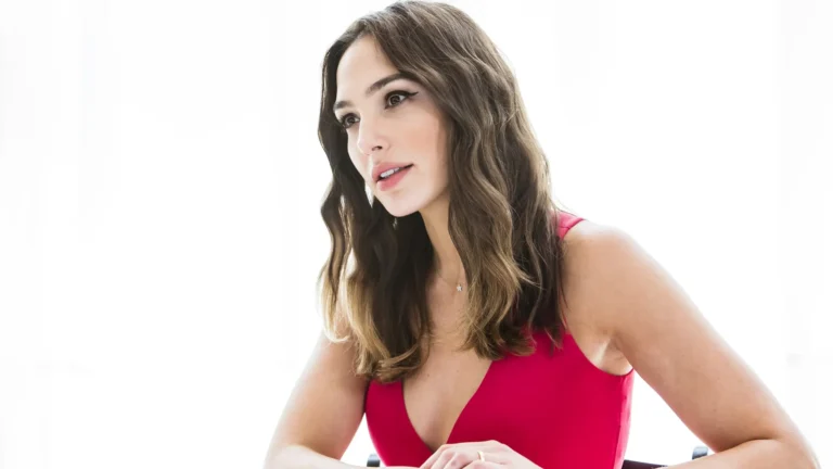 Gal Gadot wearing an elegant red dress in a bright studio portrait wallpaper