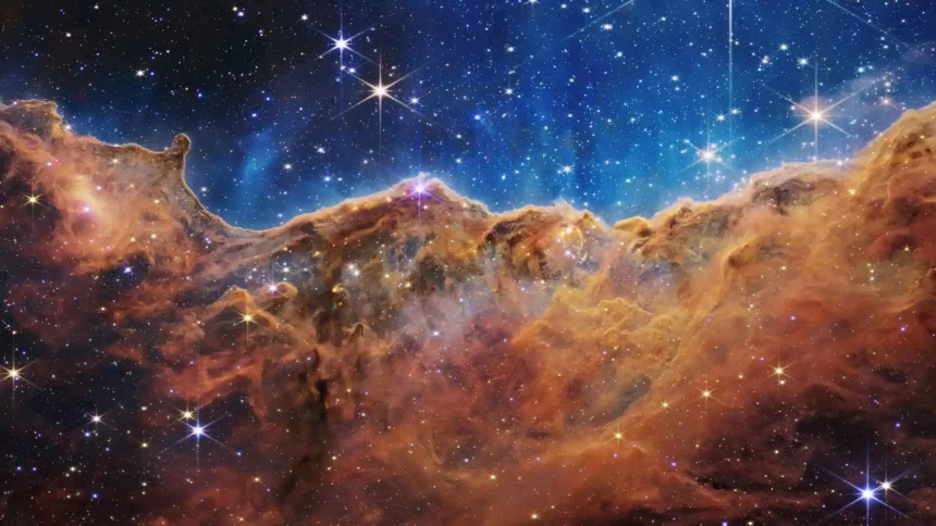 James Webb Space Telescope cosmic nebula with colorful interstellar clouds and bright stars wallpaper