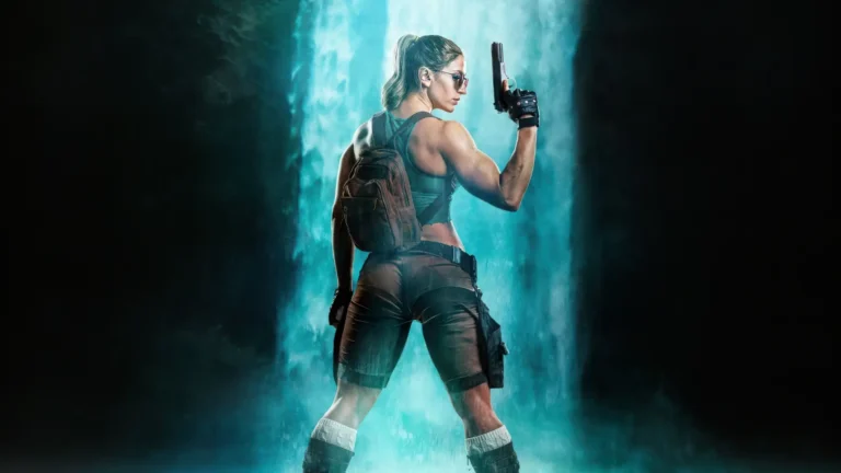 Lara Croft standing before a powerful waterfall with expedition gear and pistol wallpaper