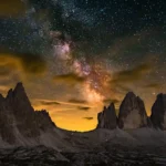 Milky Way Above Tremontana Lavaredo with the Milky Way galaxy illuminating rugged mountain peaks beneath a star-filled night sky wallpaper