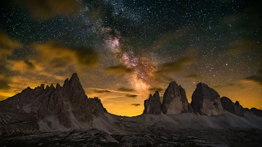 Milky Way Above Tremontana Lavaredo with the Milky Way galaxy illuminating rugged mountain peaks beneath a star-filled night sky wallpaper