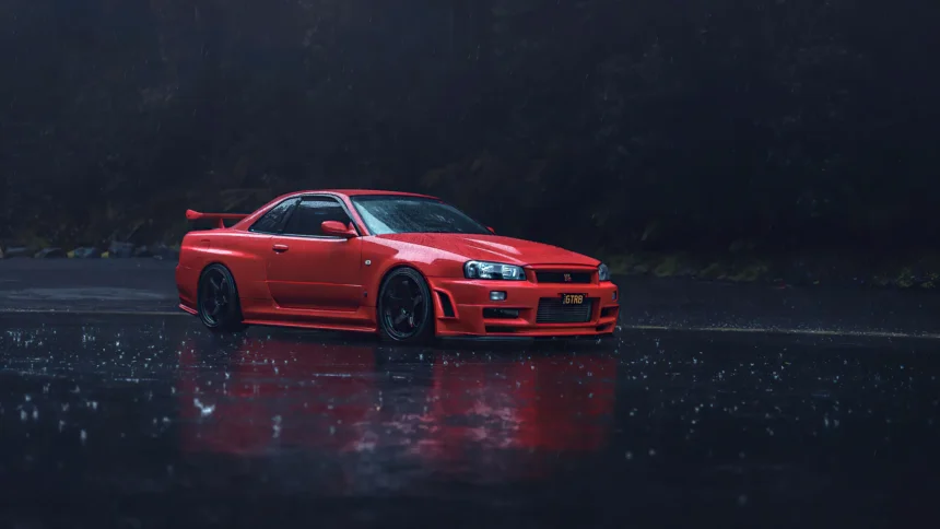 Red Nissan Skyline GT-R R34 parked on a rainy road UHD wallpaper