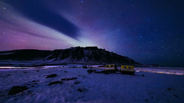 Northern Lights above a frozen snowy landscape under a star-filled Arctic sky UHD wallpaper