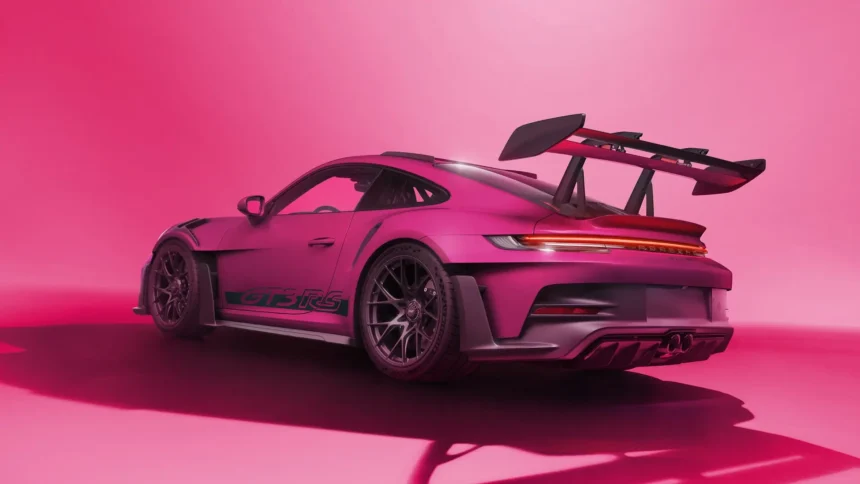 Pink Porsche 911 GT3 RS supercar with large rear wing in modern studio wallpaper