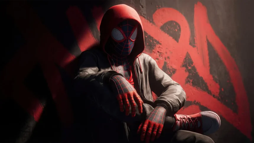 Miles Morales Spider Man in hoodie sitting against urban graffiti wall wallpaper