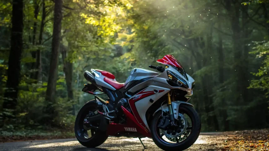 Yamaha R1 sportbike parked on a forest road with sunlight shining through trees wallpaper