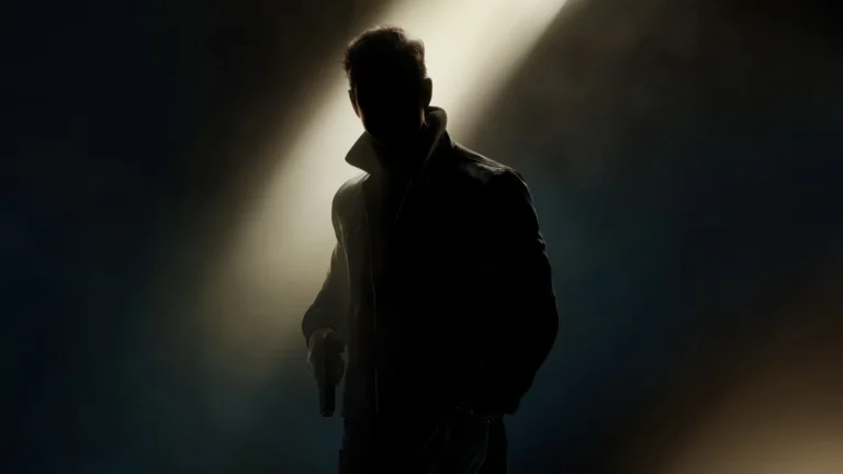 James Bond emerging from the shadows holding a pistol in a cinematic 007 UHD wallpaper