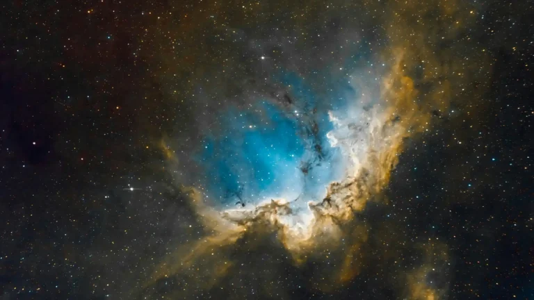 Blue cosmic nebula surrounded by glowing stars in deep space UHD wallpaper
