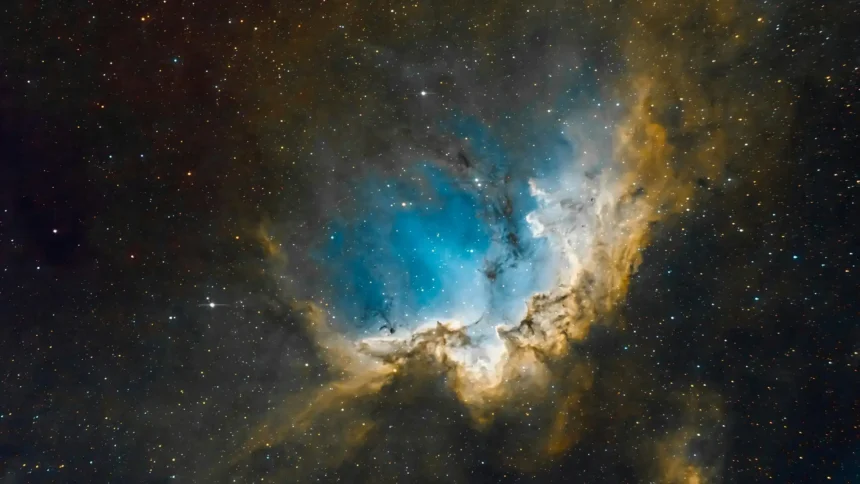 Blue cosmic nebula surrounded by glowing stars in deep space UHD wallpaper