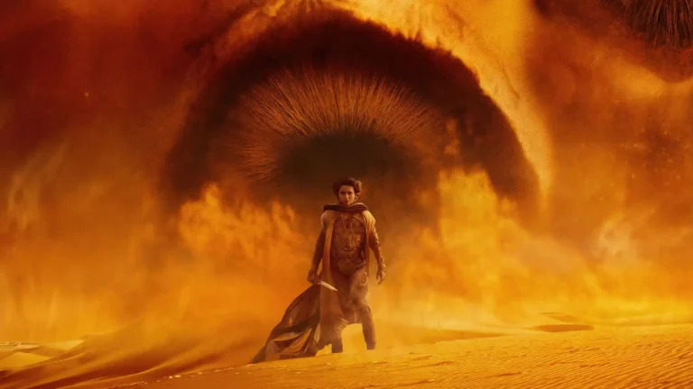 Paul Atreides standing beneath the giant Eye of Arrakis surrounded by golden desert sands in Dune Part Two Ultra HD wallpaper
