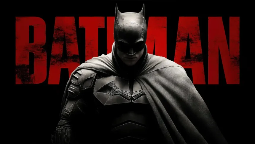 The Batman standing in front of the iconic red Batman logo in a cinematic DC superhero poster UHD wallpaper