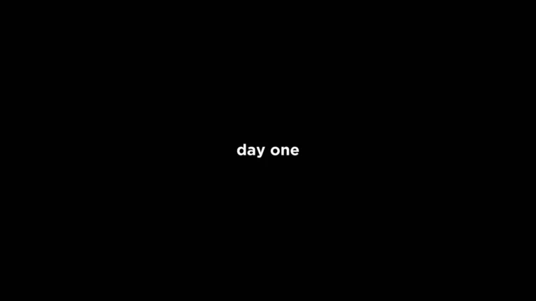 Day One motivational quote in white typography centered on a clean black minimalist background wallpaper.