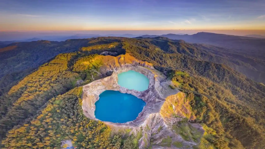Kelimutu Crater Lakes in Indonesia with blue and turquoise volcanic lakes surrounded by lush mountains at golden hour wallpaper.