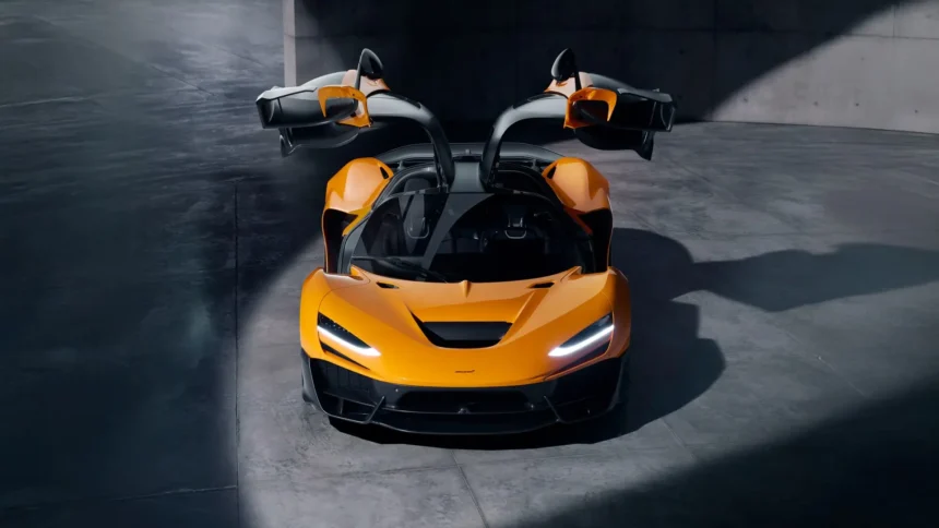 McLaren W1 orange hypercar with raised butterfly doors, LED headlights, and aerodynamic carbon fiber body wallpaper.