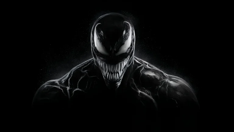 Venom Black Symbiote with white eyes and sharp teeth emerging from dark background UHD wallpaper