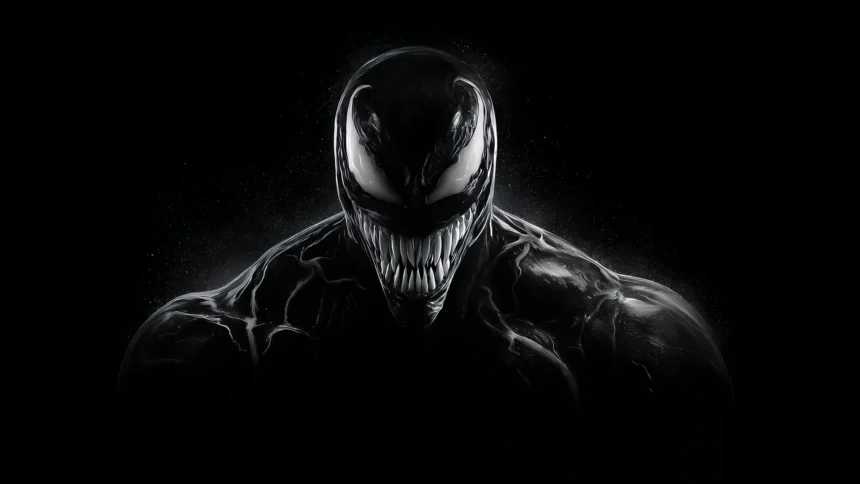 Venom Black Symbiote with white eyes and sharp teeth emerging from dark background UHD wallpaper