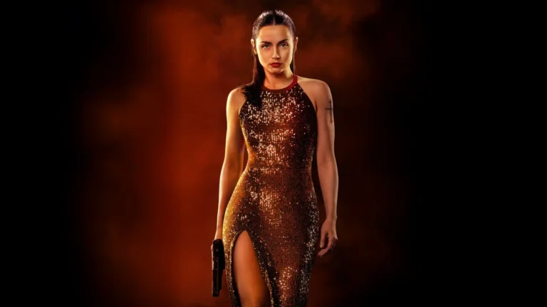 Ana de Armas as Eve Macarro in a sparkling dress holding a pistol in Ballerina movie wallpaper.