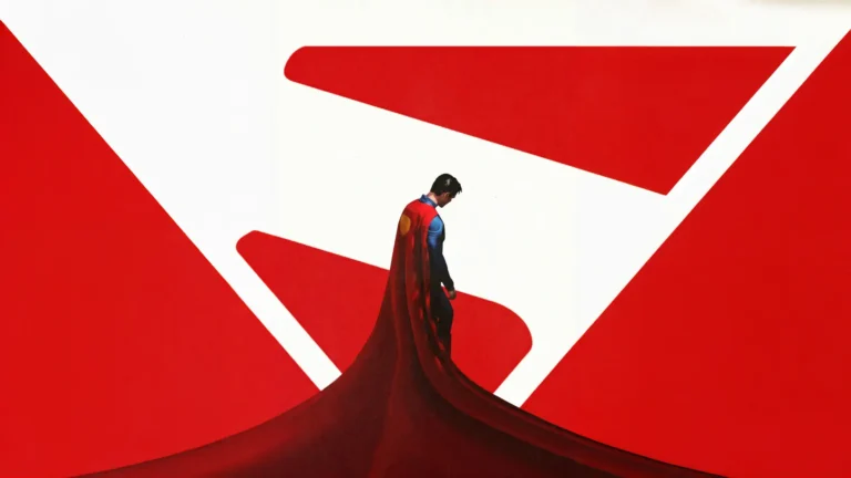 David Corenswet as Superman standing with his flowing red cape against a minimalist red and white Superman symbol background wallpaper.