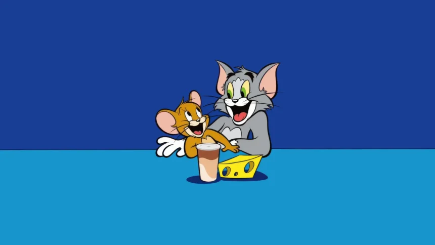Tom and Jerry laughing together with cheese and a drink on a simple blue background cartoon wallpaper.