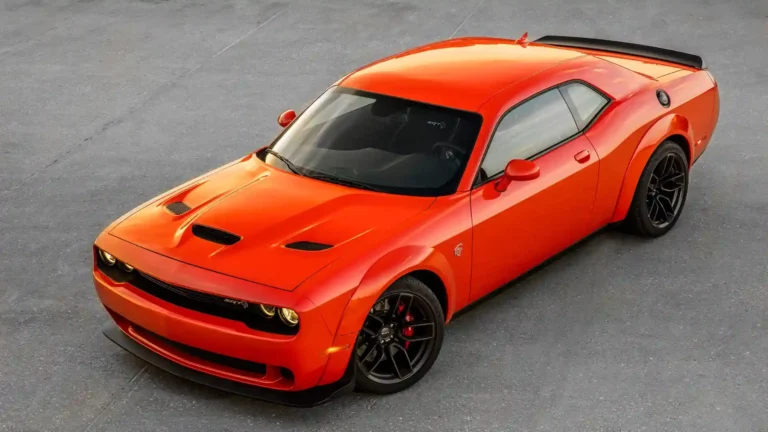 Dodge Challenger SRT Hellcat Widebody in bright orange with black wheels and aggressive muscle car styling wallpaper.