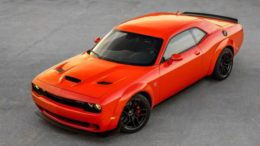 Dodge Challenger SRT Hellcat Widebody in bright orange with black wheels and aggressive muscle car styling wallpaper.